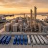 Illustration of a bulk liquid terminal with stainless steel glycol storage tanks and chemical tankers at a port